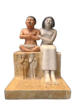 A painted limestone statue of a family on a block-shaped seat. On the left, Seneb, a man of short stature sits cross-legged on top of the block. He has reddish-brown skin, short black hair and a white